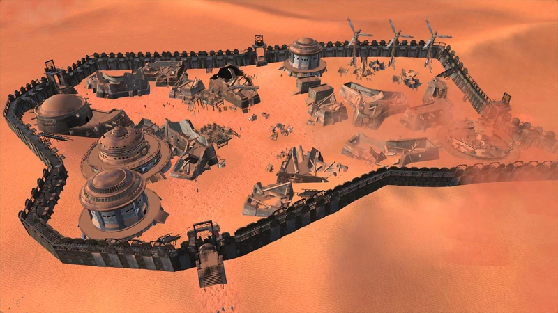Stoat from above — a continuous crenellated wall around stepped domed buildings, towers, and a spread of collapsed wreckage